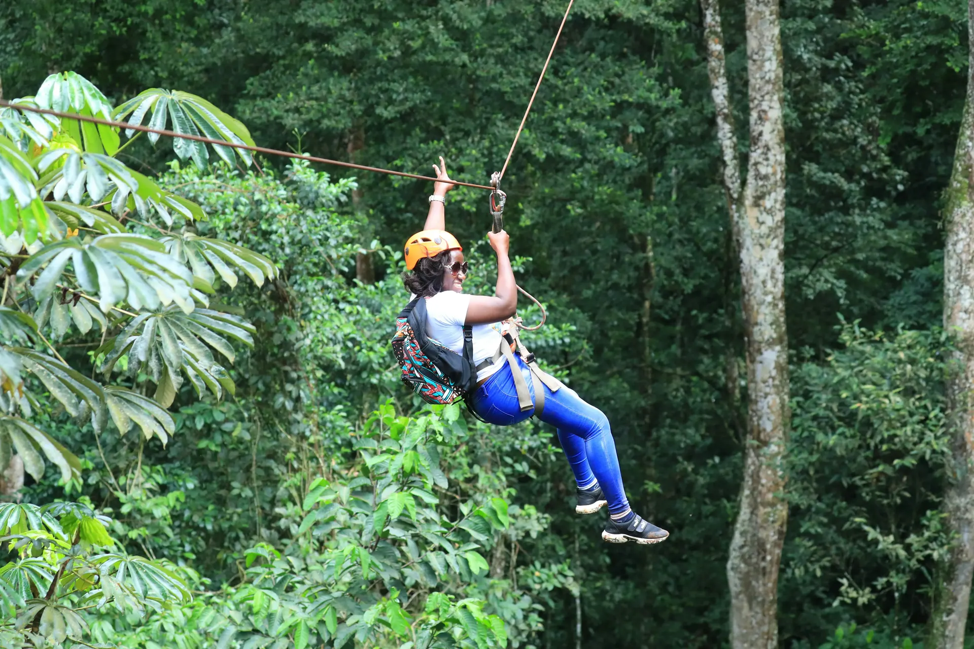 Traveler zip-lining through the jungle canopy in Belize