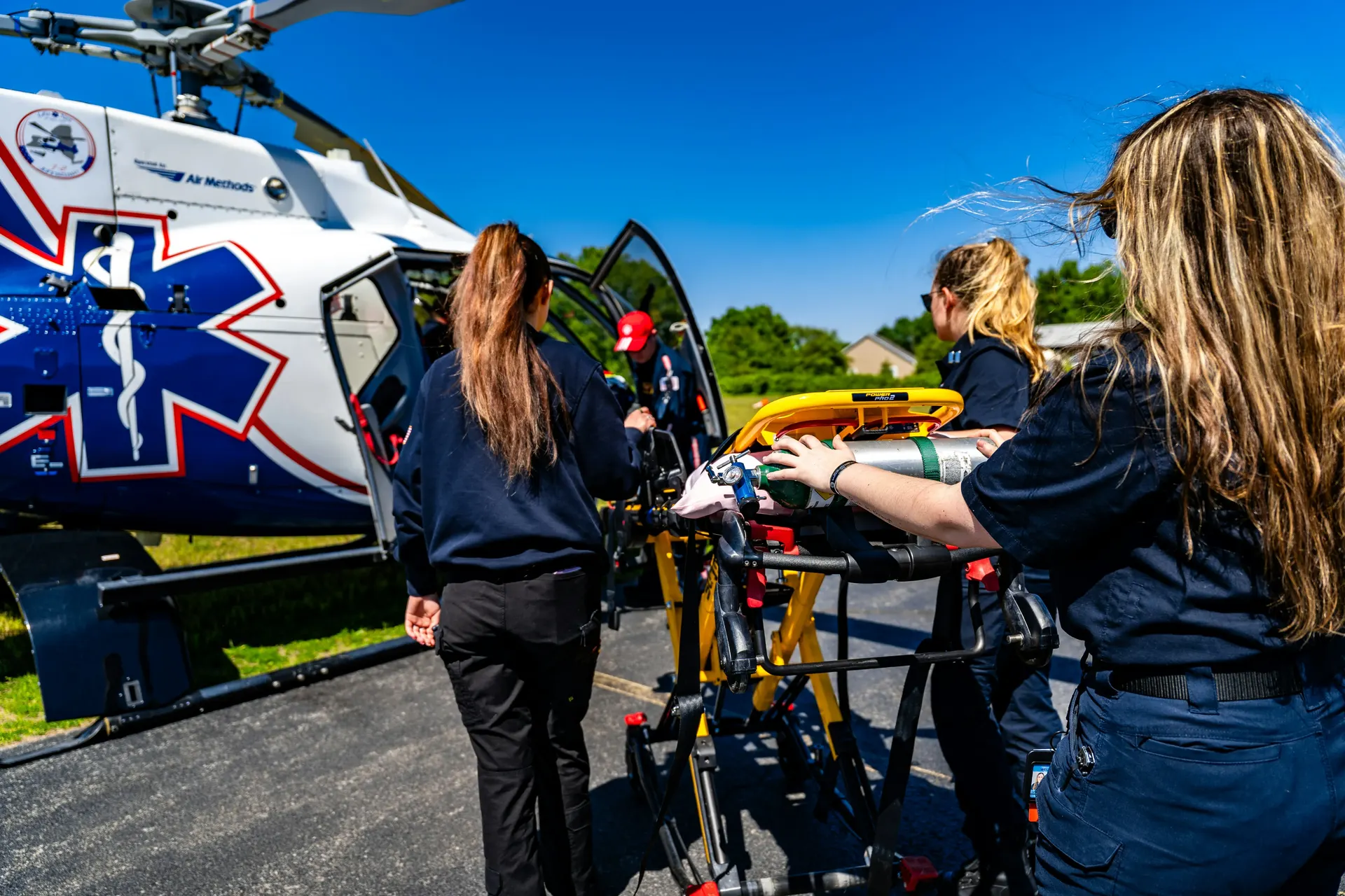 Medical team loading a patient into an air ambulance helicopter