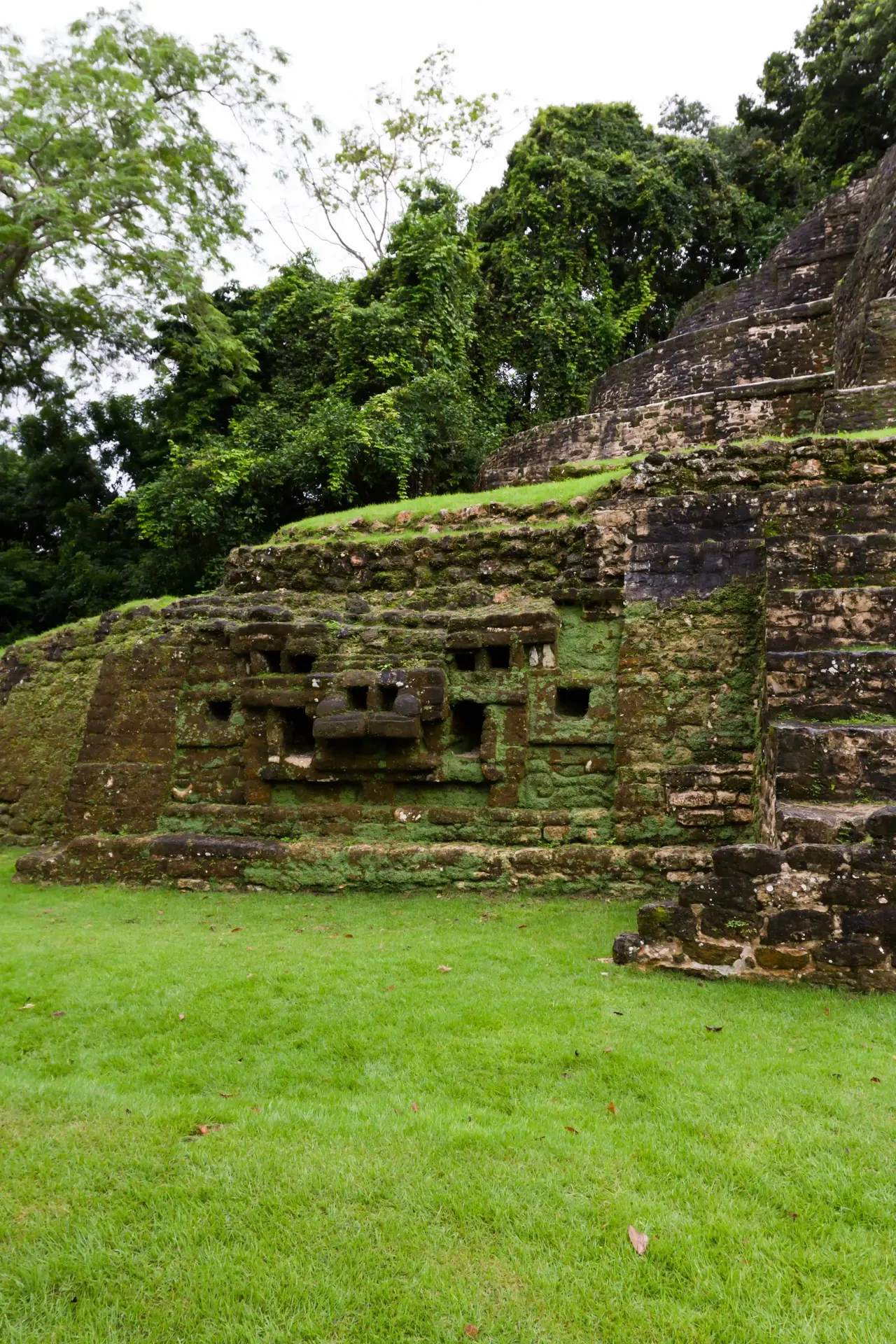 Carved mask on the Jaguar Temple at the ancient Maya city of Lamanai in Belize