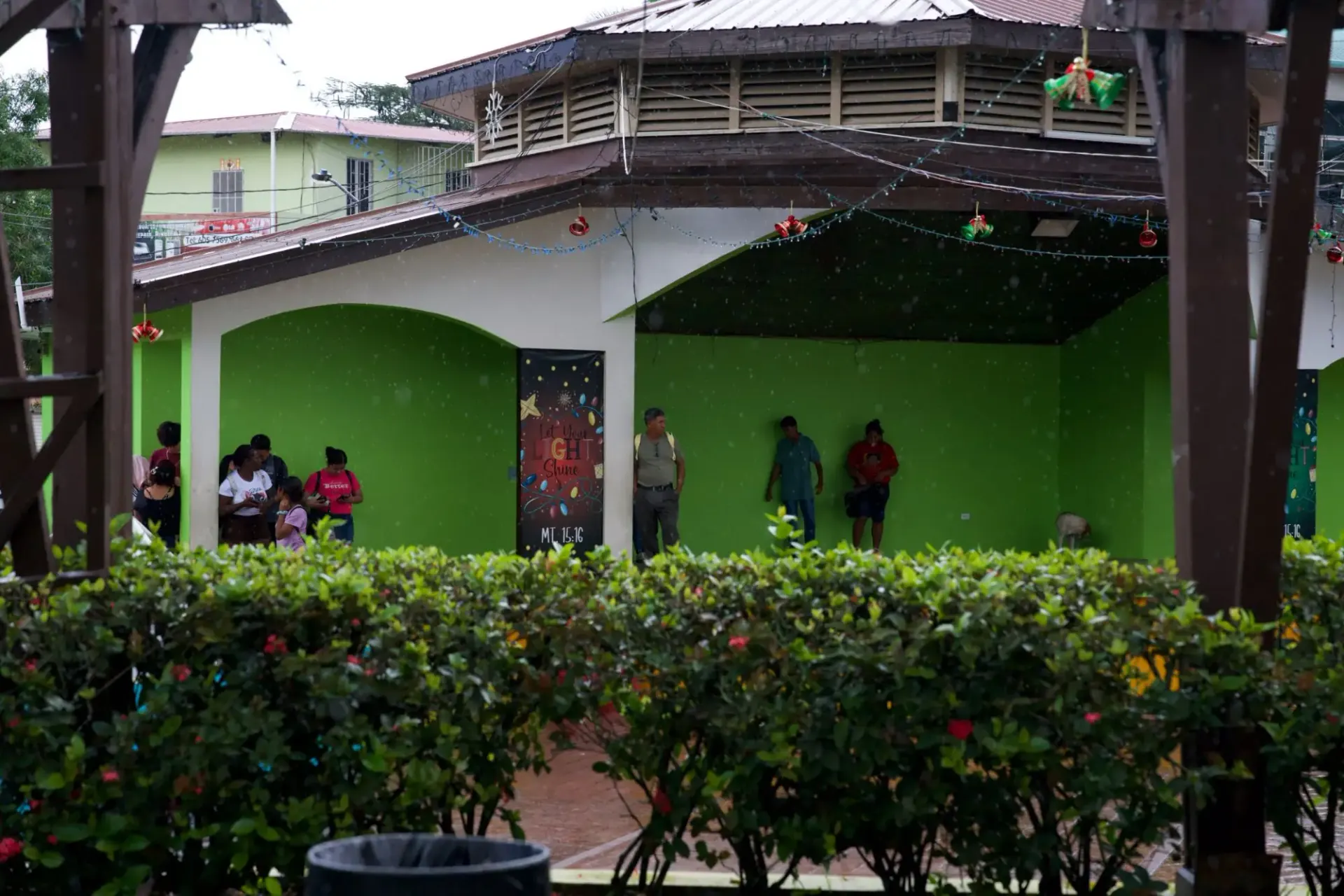 Christmas bells, lights and a Let Your Light Shine banner decorating the town plaza pavilion in San Ignacio, Belize