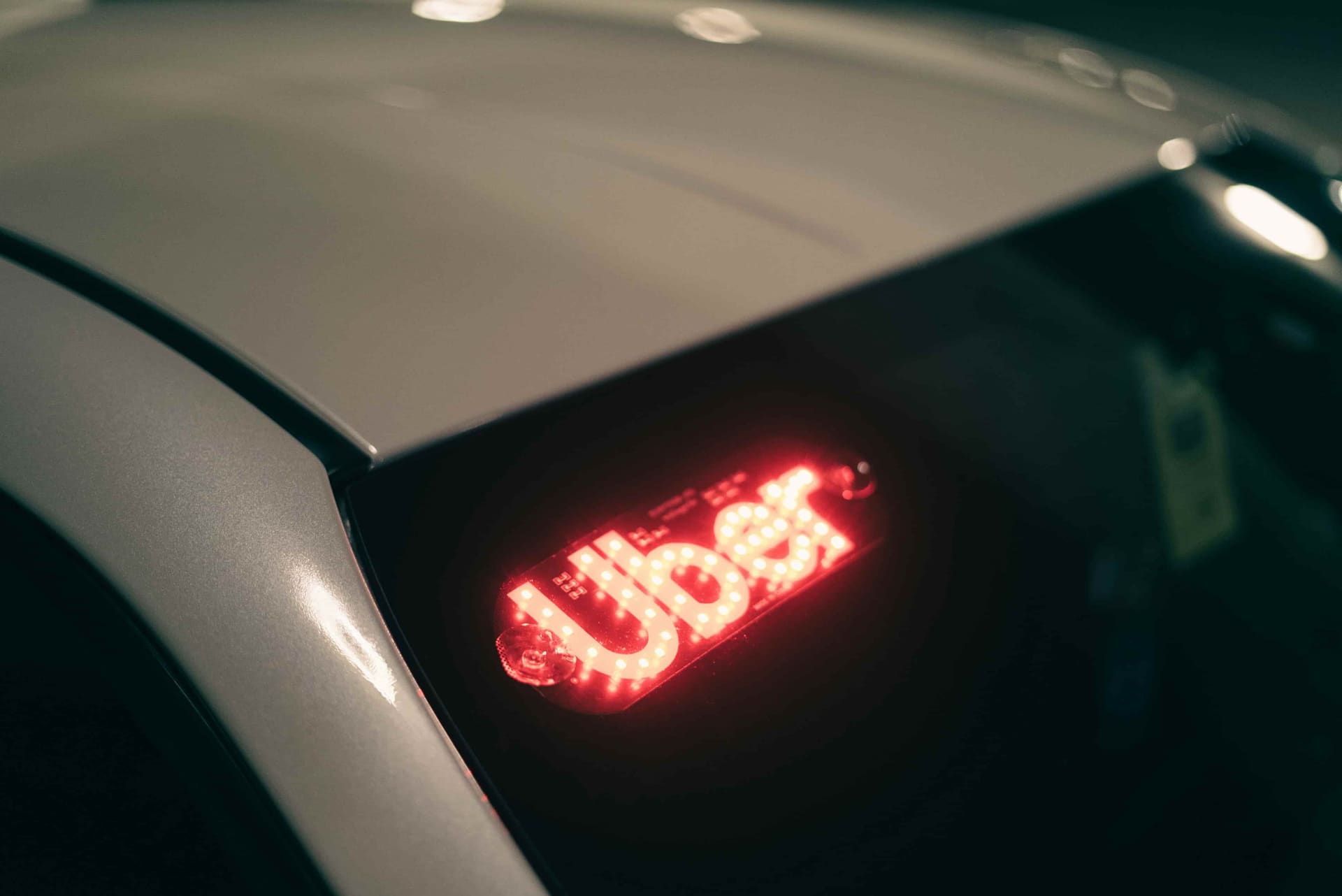 Illuminated Uber sign on a car, used for a Belize guide explaining that rideshare apps do not operate there