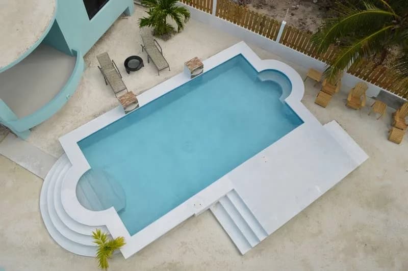 Aerial view of the pool and sun loungers at Bay Towers Caye Caulker