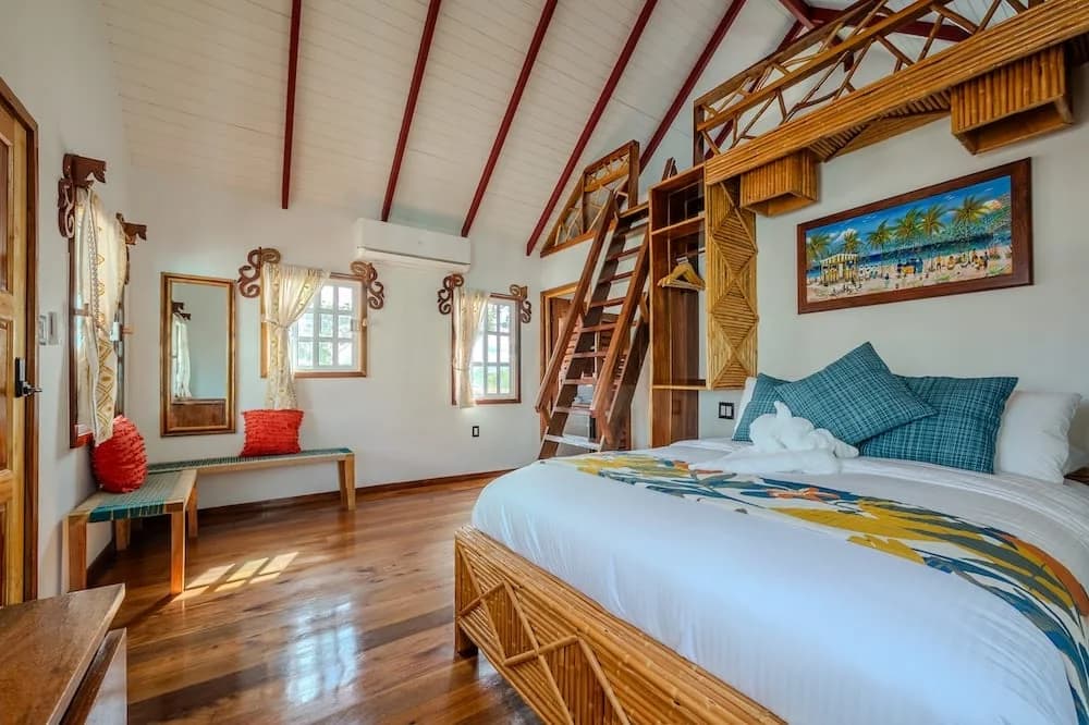 Bedroom interior of the HoneyCreeper cabana at Beaches and Dreams, Hopkins, Belize