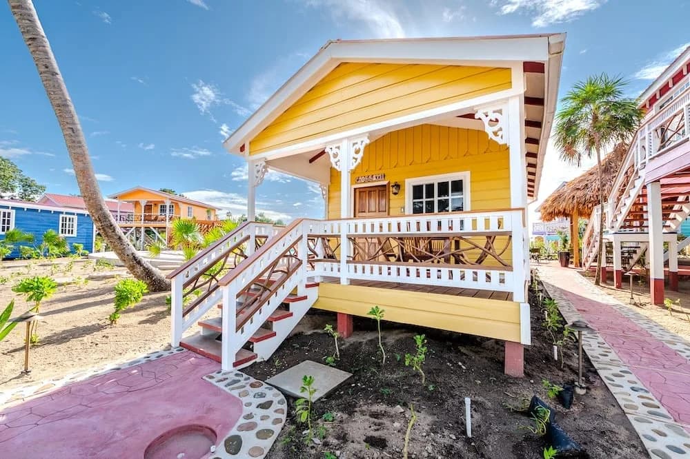 Colorful yellow cabana exterior at Beaches and Dreams resort, Hopkins, Belize