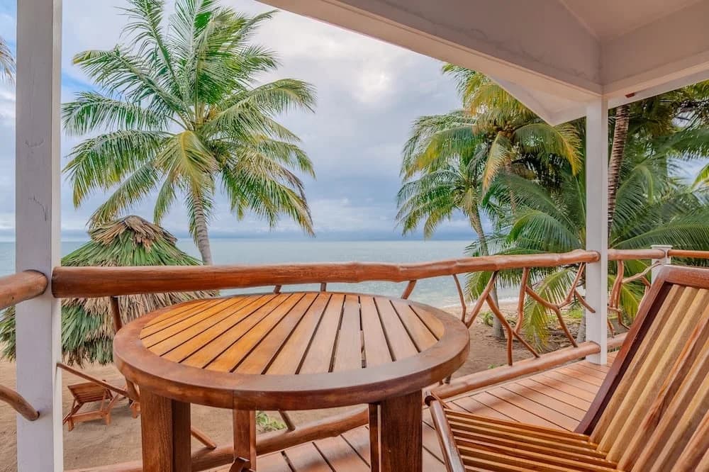 Private balcony with palm and ocean view at Beaches and Dreams resort, Hopkins, Belize