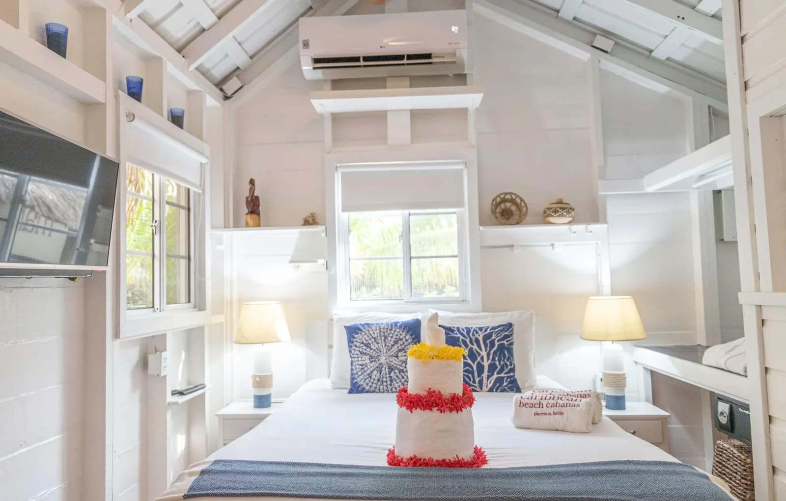 Nautical-themed bedroom with white shiplap walls inside a suite at Caribbean Beach Cabanas, Placencia