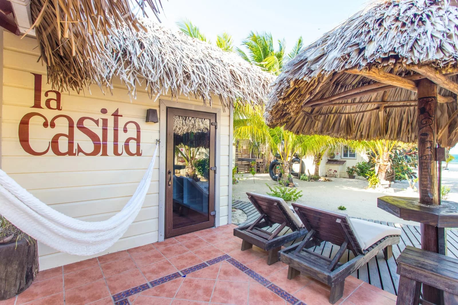 La Casita cabana entrance with hammock and lounge chairs on a shaded deck at Caribbean Beach Cabanas