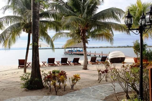 Beachfront lounge chairs and thatched-roof pier at Chabil Mar Villas overlooking the Caribbean