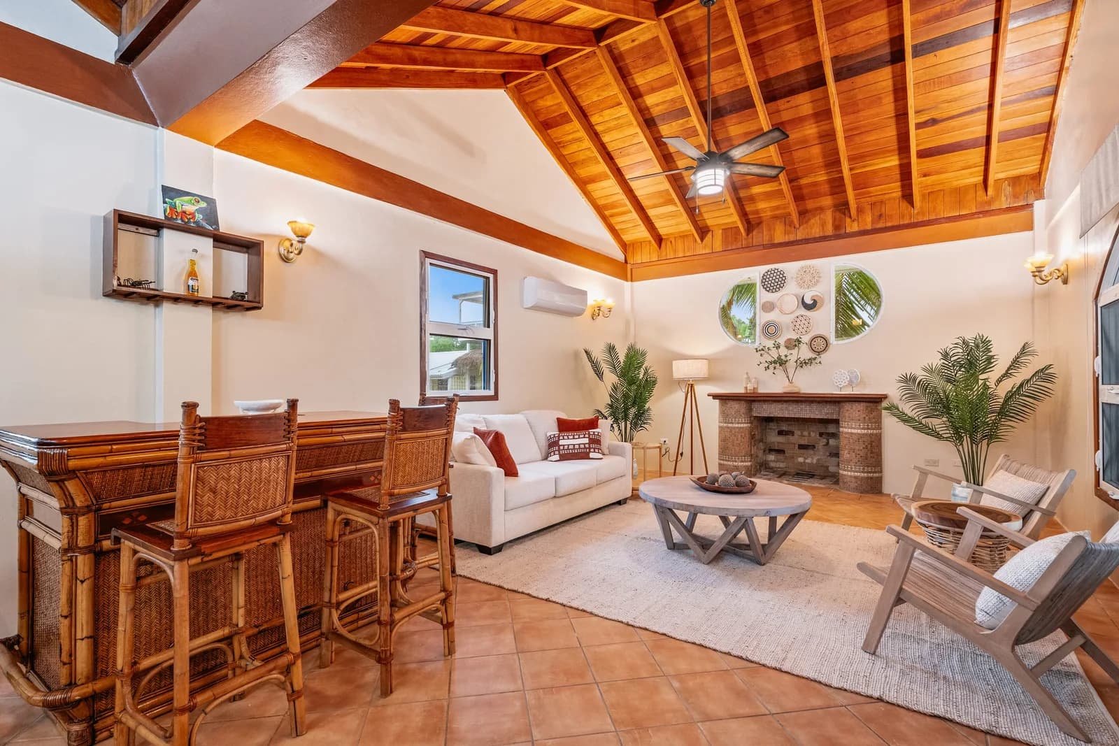 Bismarck Suite lounge and bar area at Coconut Row Boutique Hotel with rattan bar stools and a high vaulted wood ceiling