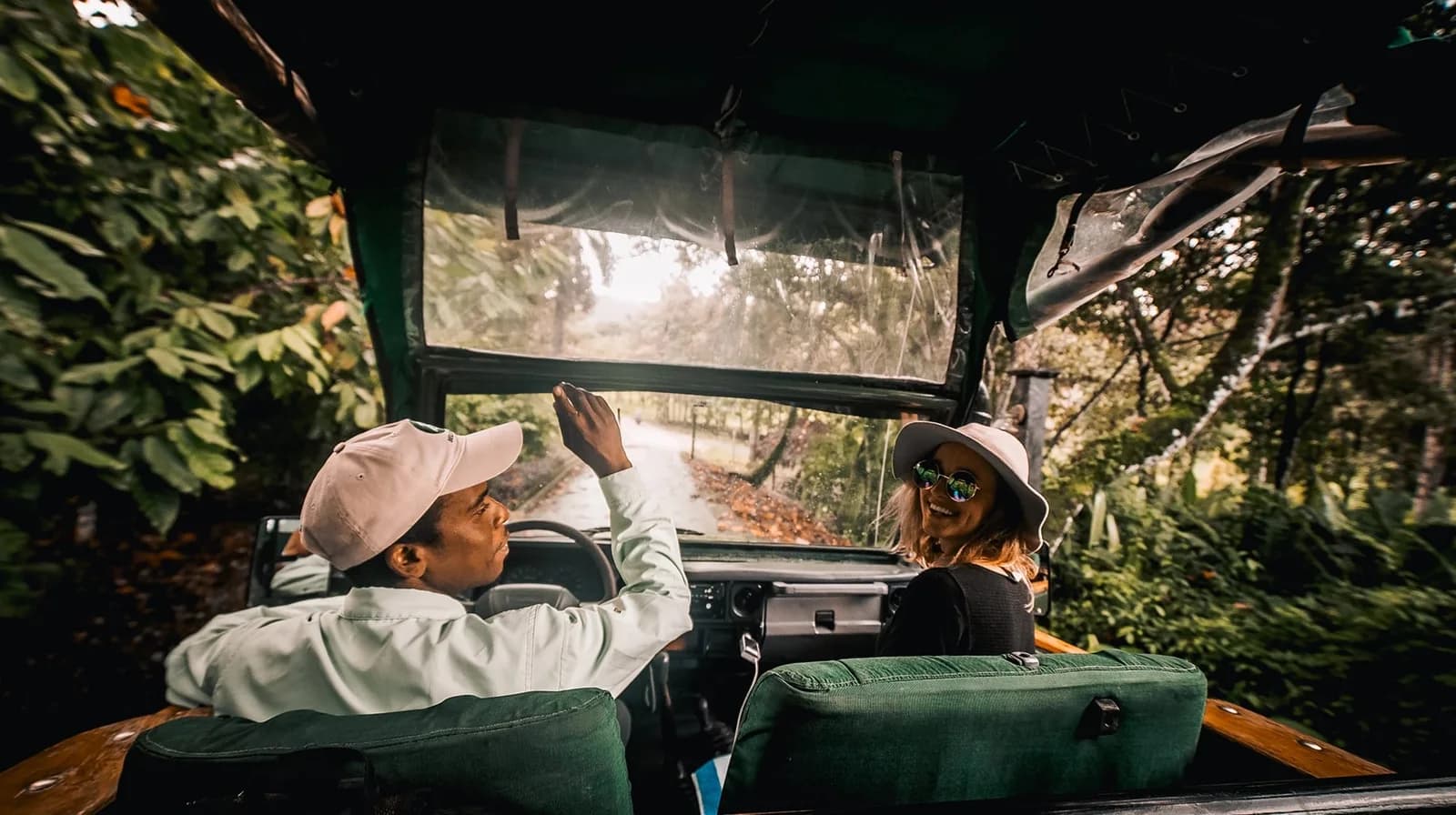 Guests on a guided open air jungle tour vehicle exploring the rainforest trails around Copal Tree Lodge