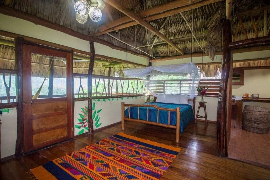 Deluxe Riverside Cabana bedroom interior at Cotton Tree Lodge, Belize