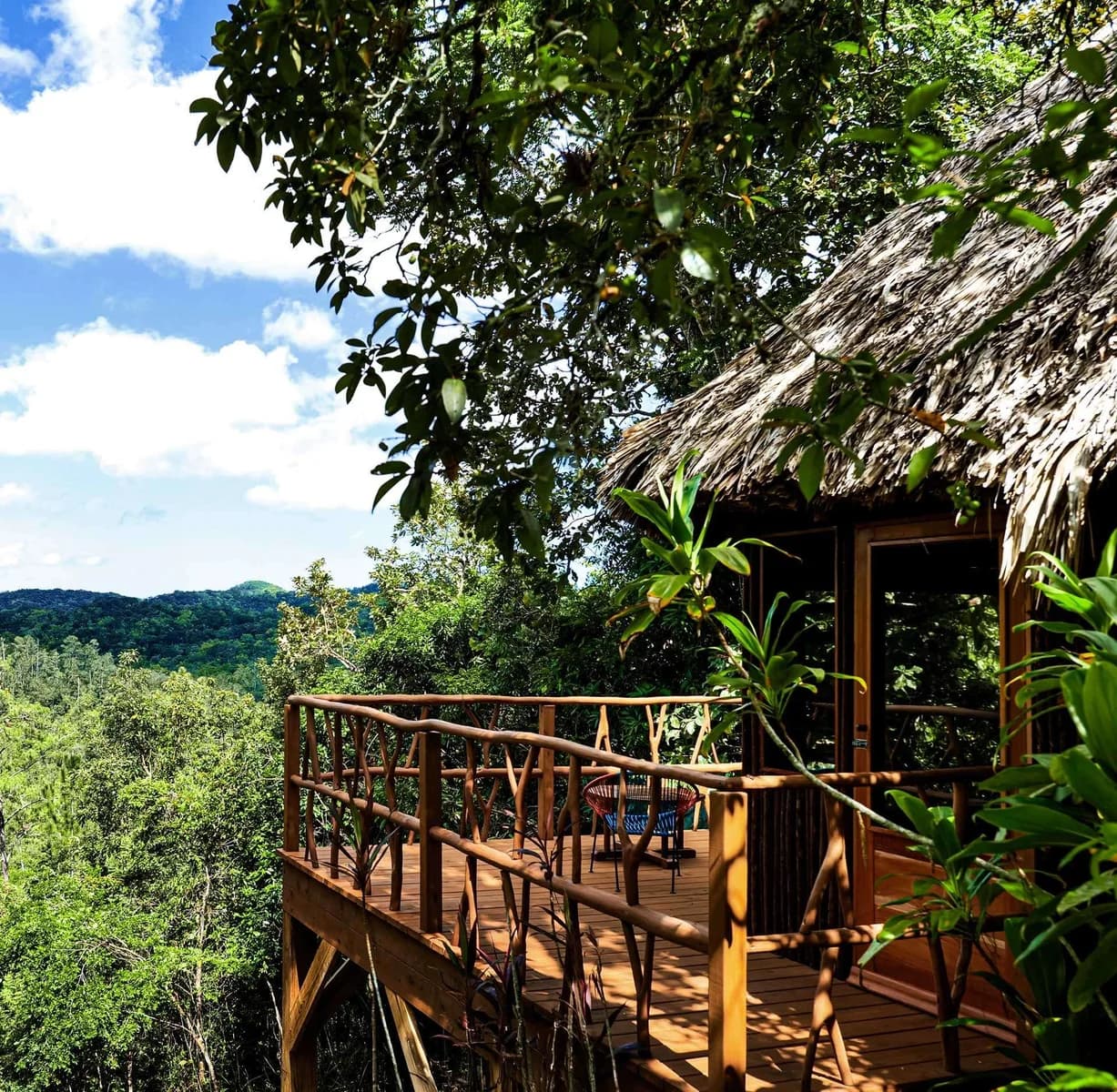 Private veranda of a Mountain View Cabana overlooking the forested hills around Gaia Riverlodge