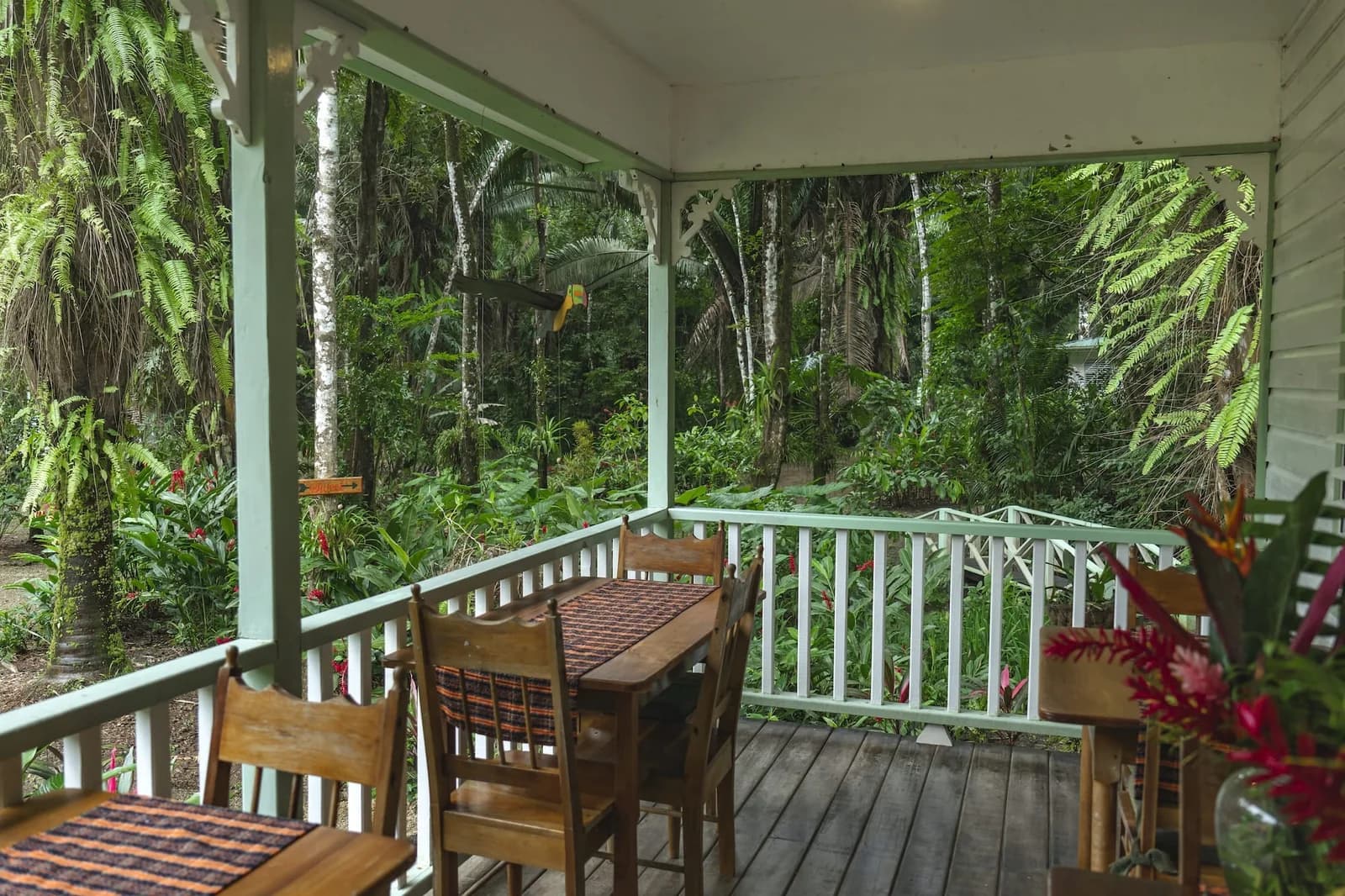 Covered dining porch with private tables at Hickatee Cottages overlooking the rainforest