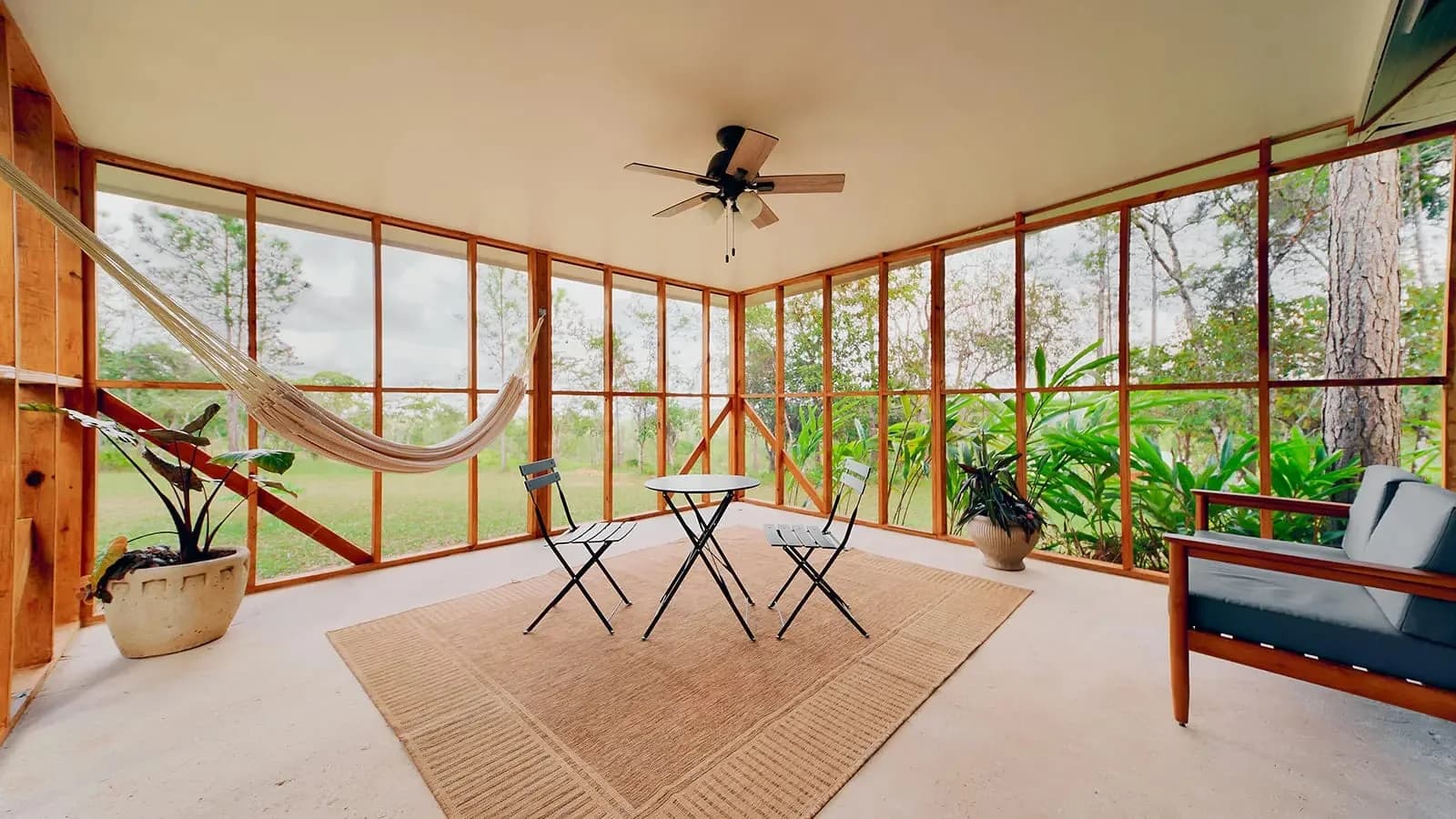 Screened porch seating area with hammock in the Family Cottage, Hidden Valley Inn