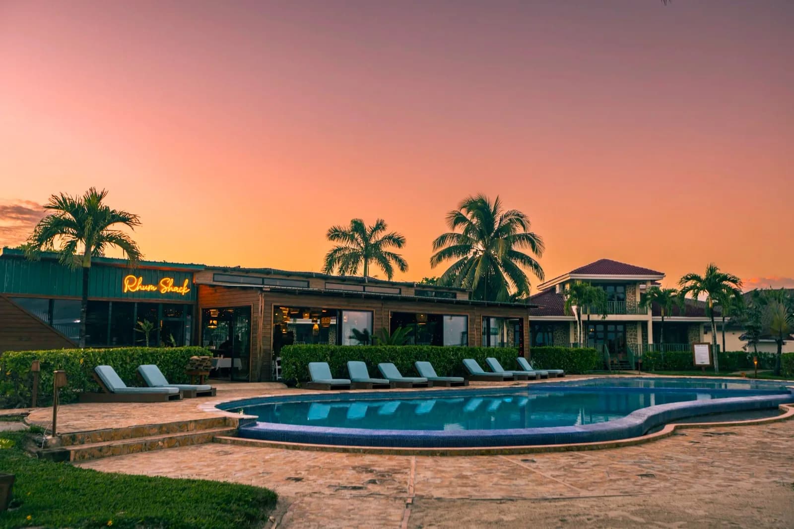 Hopkins Bay Belize's Rhum Shack restaurant and poolside seating lit up at dusk