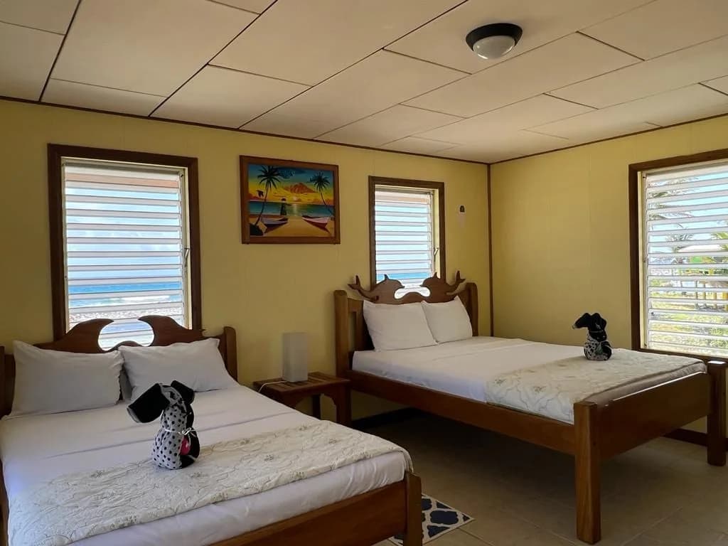Family cabana bedroom with twin beds at Isla Marisol Resort