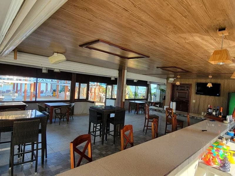 Interior of the Magic Grill Restaurant and Bar at Island Magic Beach Resort with ocean-facing seating