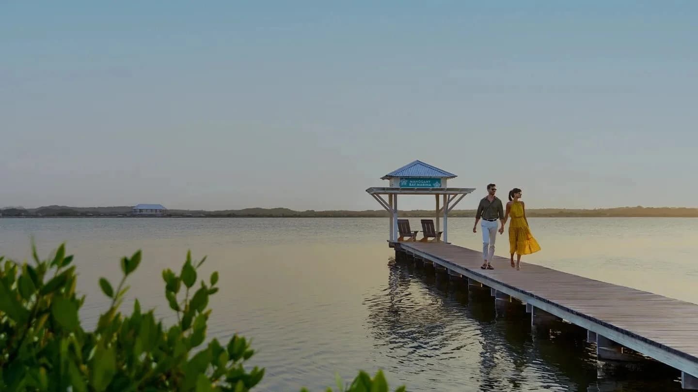 Guests relaxing on the overwater dock at Mahogany Bay Resort, San Pedro, Ambergris Caye, Belize