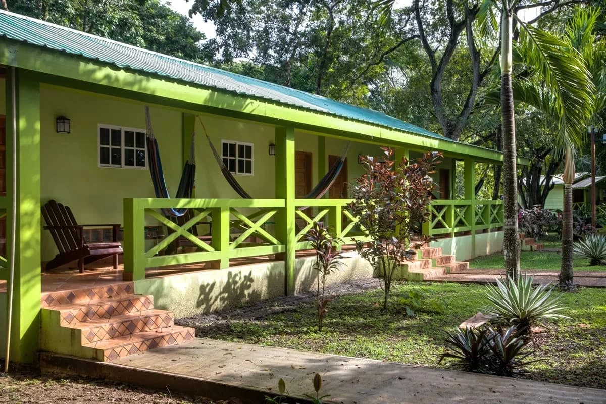 Row of King Deluxe rooms at Midas Belize with private verandahs, hammocks and tropical garden grounds