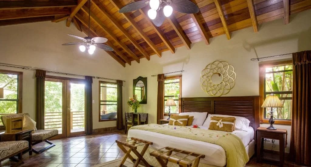 Vaulted wooden ceiling and king bed inside a Mystic River Resort Studio Suite