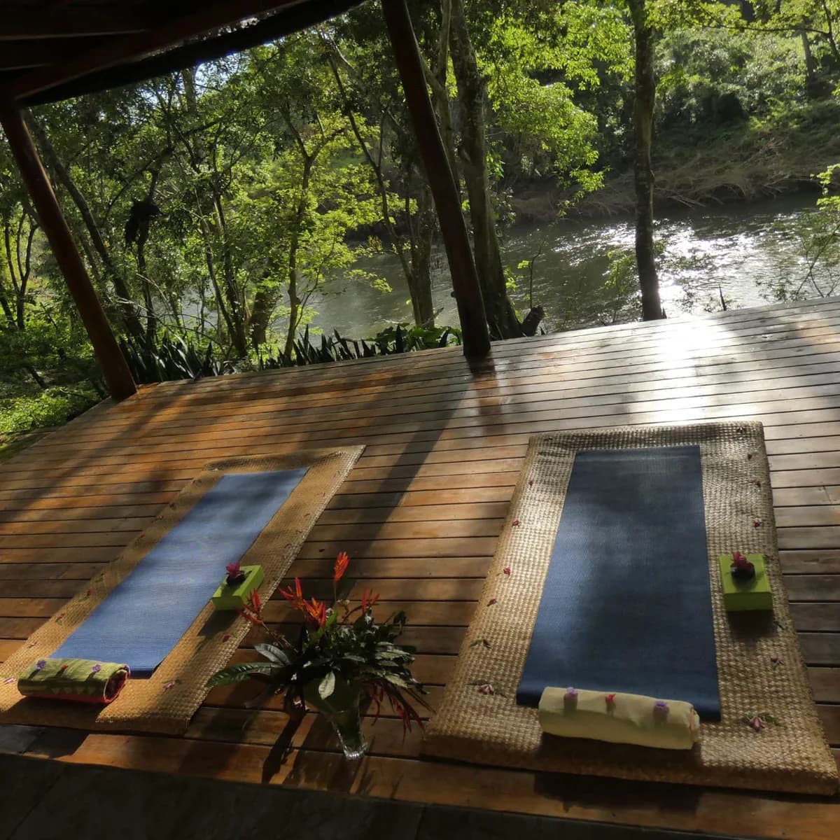Yoga mats laid out on Mystic River Resort's riverside deck overlooking the Macal River