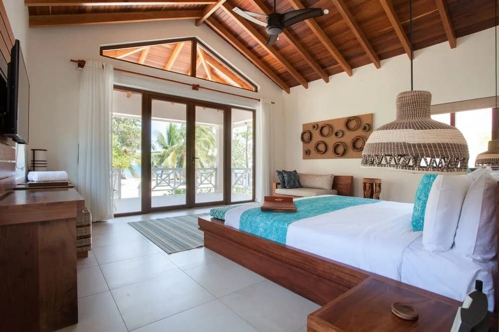 Ocean-view bedroom with private balcony at Naia Resort and Spa, Placencia, Belize