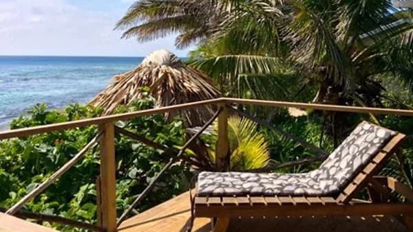 Palapa-shaded oceanview lounge deck at Off The Wall Dive Center & Resort