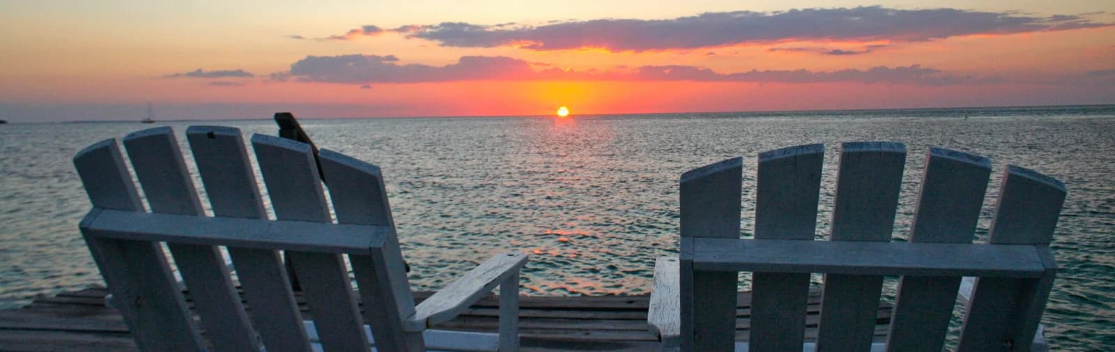 Sunset over the private hotel dock at Sea Dreams Hotel, Caye Caulker, Belize