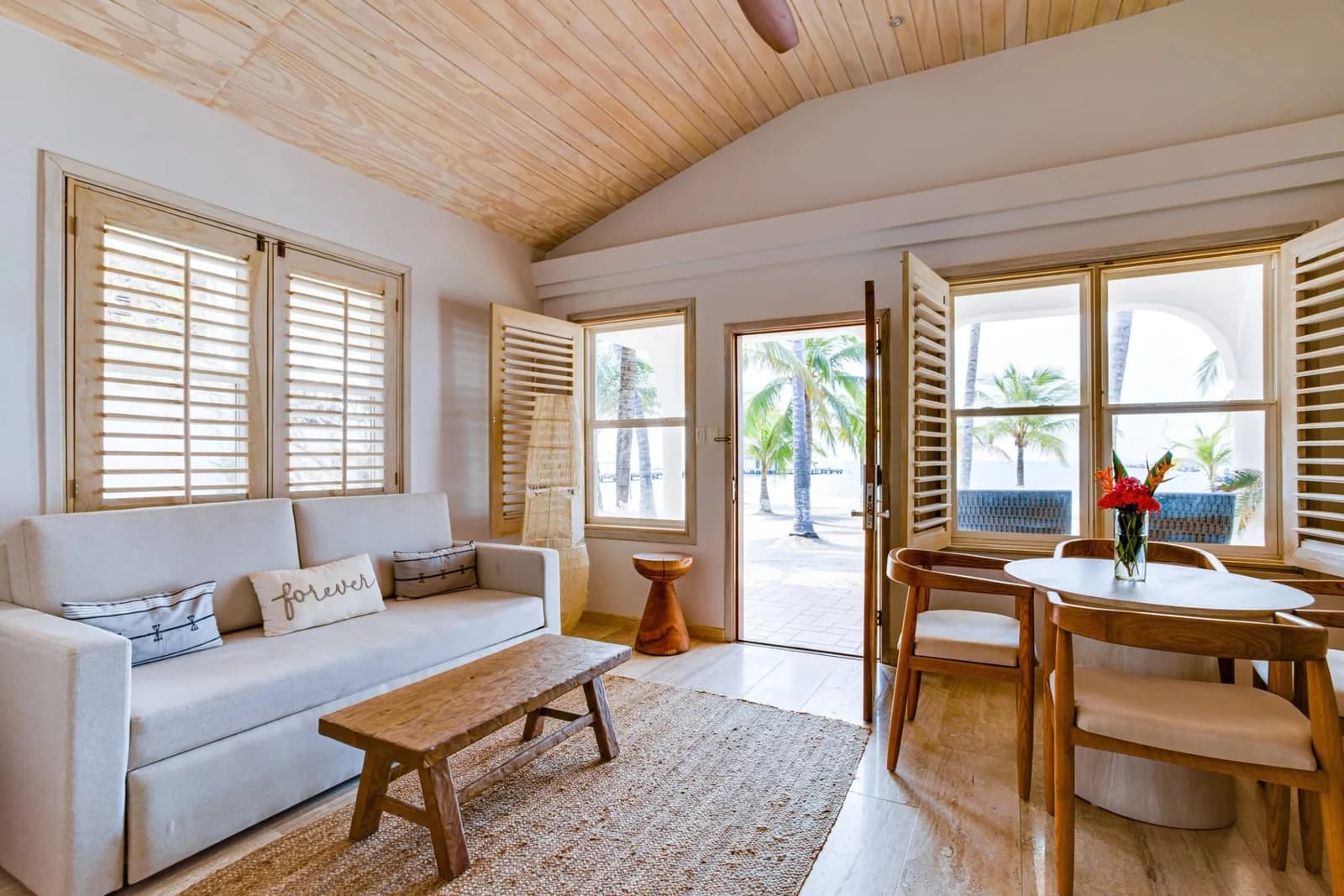 Living and dining area inside an oceanview villa at The Placencia Resort, Belize
