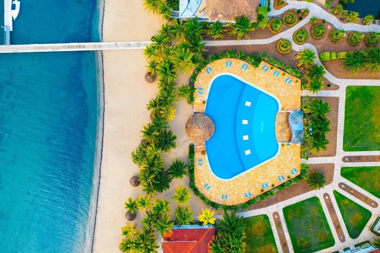 Overhead view of the swimming pool and private beach at The Placencia Resort, Maya Beach, Belize