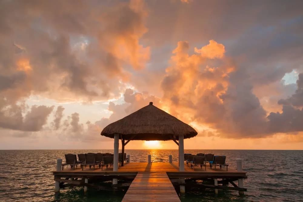 Weezie's Ocean Front Hotel private pier and dock at sunrise, Caye Caulker, Belize