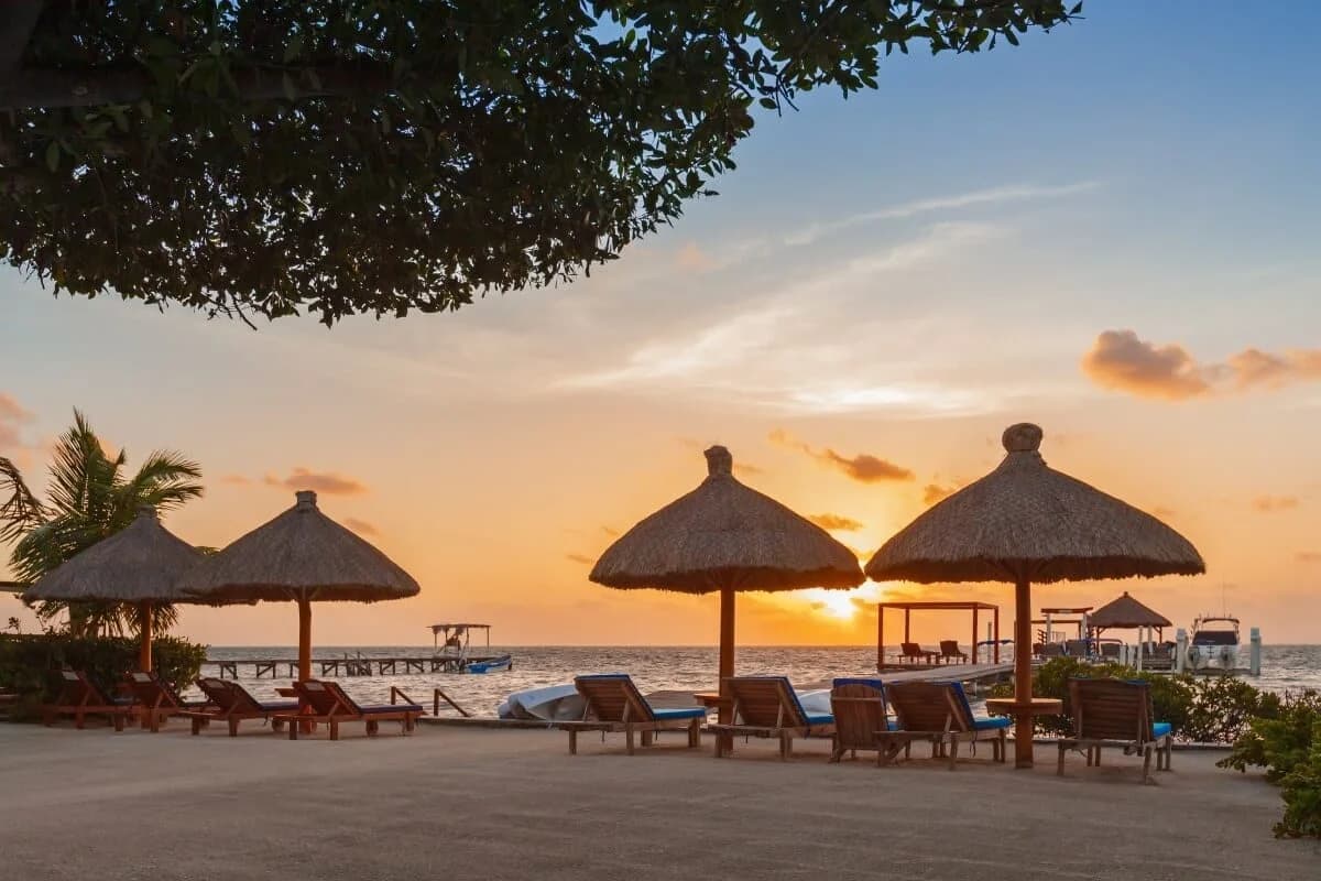 Lounge chairs at sunrise on the grounds of Weezie's Ocean Front Hotel, Caye Caulker, Belize