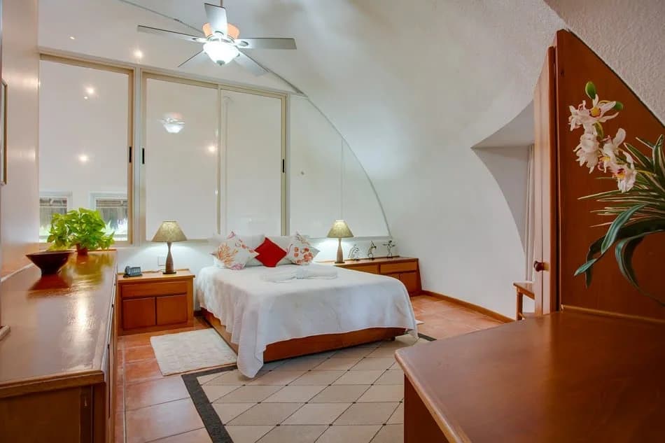Bedroom inside a Three Bedroom Suite at Xanadu Island Resort showing the resort's signature curved monolithic dome ceiling
