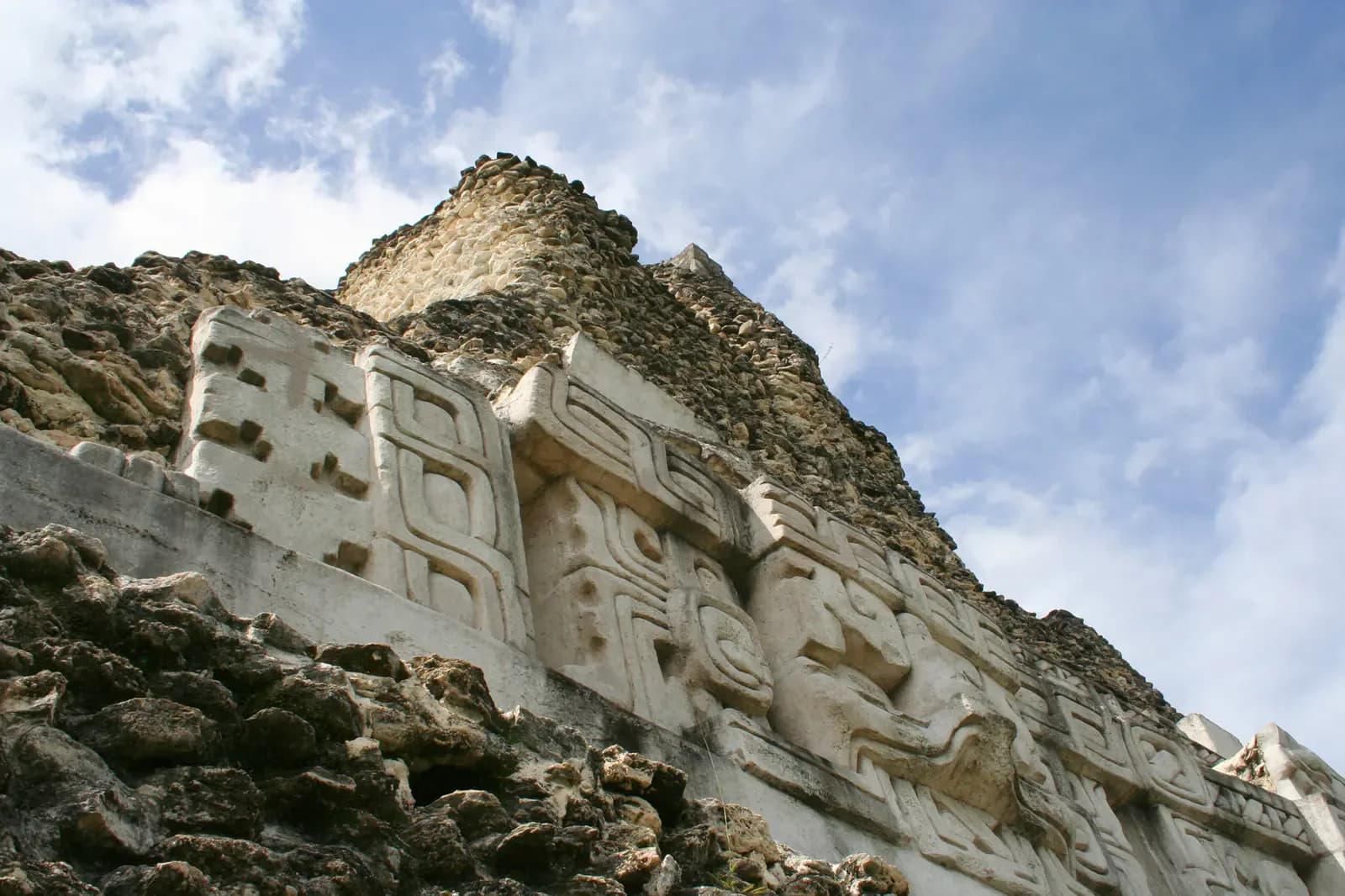 The carved stucco frieze near the top of El Castillo