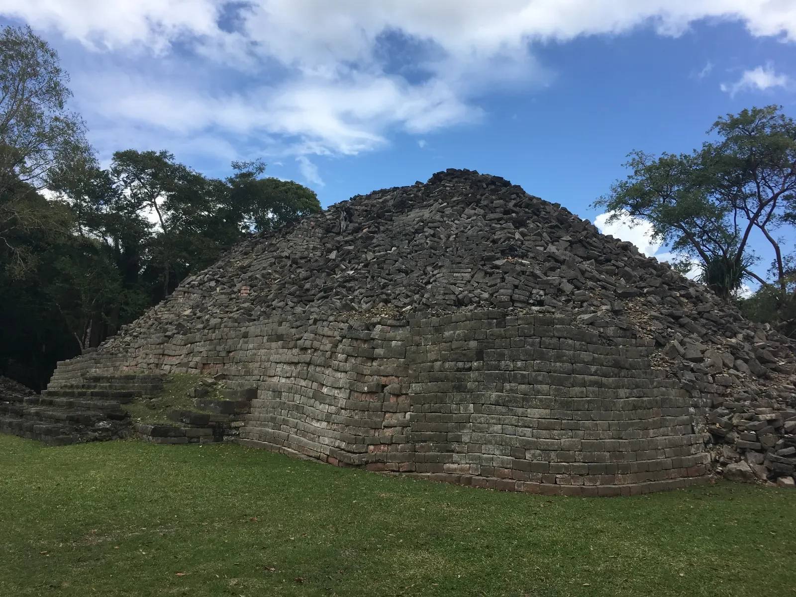 Mortarless stone pyramid with collapsed upper tiers at Lubaantun, Toledo District, Belize